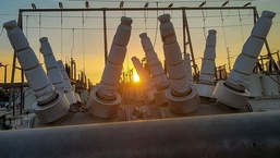 California Power Blackouts: The sun sets behind a high power station in downtown Los Angeles.