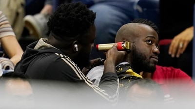 A fan gets a haircut as Nick Kyrgios plays Karen Khachanov during the quarterfinals of the US Open (AP) A fan gets a haircut as Nick Kyrgios plays Karen Khachanov during the quarterfinals of the US Open (AP)