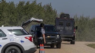 An armoured RCMP vehicle (right) drives past a police roadblock set up on the James Smith Cree First Nation reservation in Saskatchewan, Canada, on Tuesday. (AP) An armoured RCMP vehicle (right) drives past a police roadblock set up on the James Smith Cree First Nation reservation in Saskatchewan, Canada, on Tuesday. (AP)