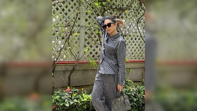 Karisma Kapoor ditched fancy stilettoes and teamed her look with a pair of comfy white sneakers. (Instagram/@therealkarismakapoor)