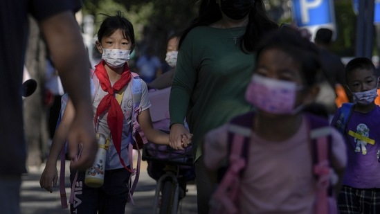 Covid In China; Students wearing face masks in Beijing,(AP)