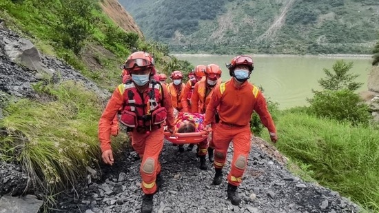 Rescue workers carry an injured person after a 6.6-magnitude earthquake in Luding county, Ganzi prefecture in China’s southwestern Sichuan province on Tuesday. (AFP)