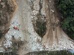 China Earthquake: Rescuers transfer an earthquake affected villager through a damaged mountain road.
