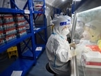 Staff members of Sichuan Provincial People's Hospital test nucleic acid samples inside a mobile laboratory set up at a sports centre, following the coronavirus disease (Covid-19) outbreak in Chengdu, Sichuan province, China