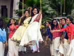 Students of Government College for Women ride a swing during Onam celebrations, in Thiruvananthapuram.(PTI)