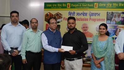 Punjab and Sind Bank officials handing over a credit sanction letter to a beneficiary in Ludhiana. (HT PHOTO)