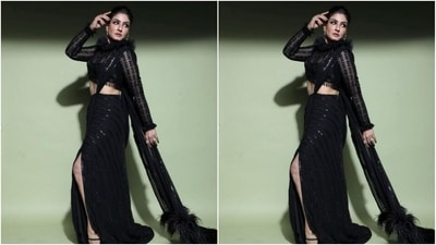 Raveena looked snatched in the black shimmery chiffon saree that featured embellishments in black resham threads and came with one thigh high slit. Raveena teamed it with a tulle black blouse featuring turtleneck details and full sleeves. (Instagram/@officialraveenatandon)