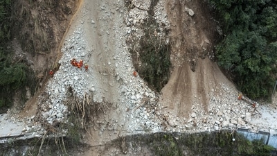China Earthquake: Rescuers transfer an earthquake affected villager through a damaged mountain road. (AP) China Earthquake: Rescuers transfer an earthquake affected villager through a damaged mountain road. (AP)