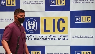 A man walks past a hoarding of Life Insurance Corporation of India (LIC) in Mumbai. (Used only for representation)