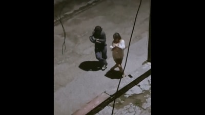 The image, taken from the dance video, shows two people dancing to Dhanush's Megham Karukatha under street light on an empty road. (Twitter/@prernadaga21) The image, taken from the dance video, shows two people dancing to Dhanush's Megham Karukatha under street light on an empty road. (Twitter/@prernadaga21)