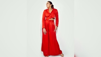 Huma Qureshi's outfit comprises a red asymmetrical cropped full-sleeved shirt and high-rise tailored trousers. (Instagram/@iamhumaq) Huma Qureshi's outfit comprises a red asymmetrical cropped full-sleeved shirt and high-rise tailored trousers. (Instagram/@iamhumaq)