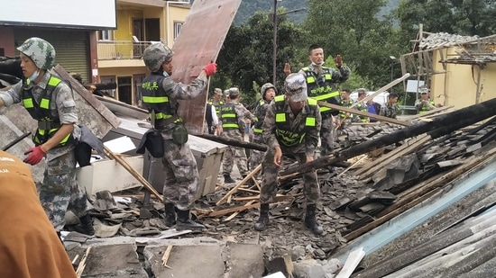 China Sichuan Earthquake: Soldiers clear debris to search for survivors at an earthquake hit Moxi Town of Luding County.(AP) China Sichuan Earthquake: Soldiers clear debris to search for survivors at an earthquake hit Moxi Town of Luding County.(AP)