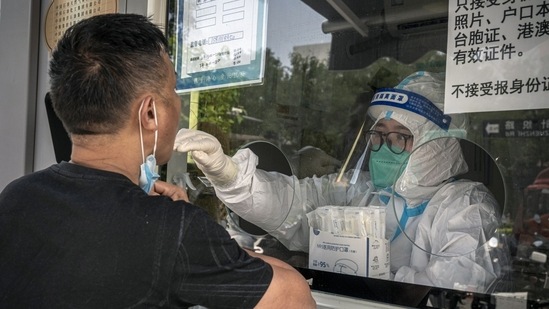 A resident at a Covid-19 testing booth in Beijing, China, on Tuesday, Aug. 30, 2022.(Bloomberg)