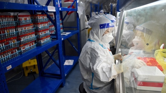 Staff members of Sichuan Provincial People's Hospital test nucleic acid samples inside a mobile laboratory set up at a sports centre, following the coronavirus disease (Covid-19) outbreak in Chengdu, Sichuan province, China(Photo via REUTERS ATTENTION EDITORS)