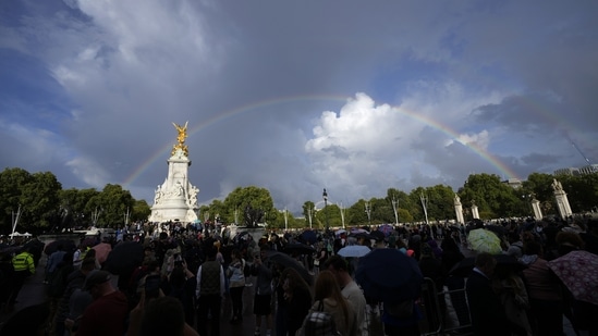 People gather outside Buckingham Palace in London as a double rainbow appears in the sky, Thursday, September. 8, 2022. (AP Photo/Frank Augstein)