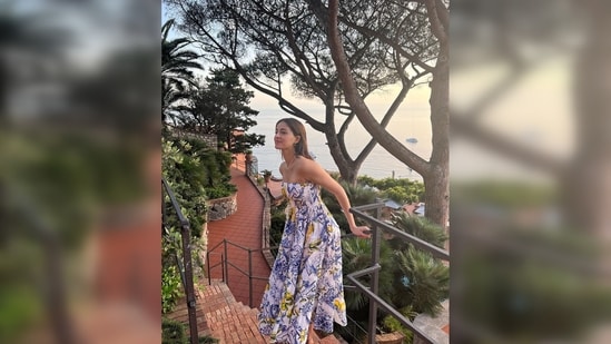 Ananya Panday made comfort her peek priority and took over the streets of Capri in a comfy printed strapless midi dress.(Instagram/@ananyapanday)