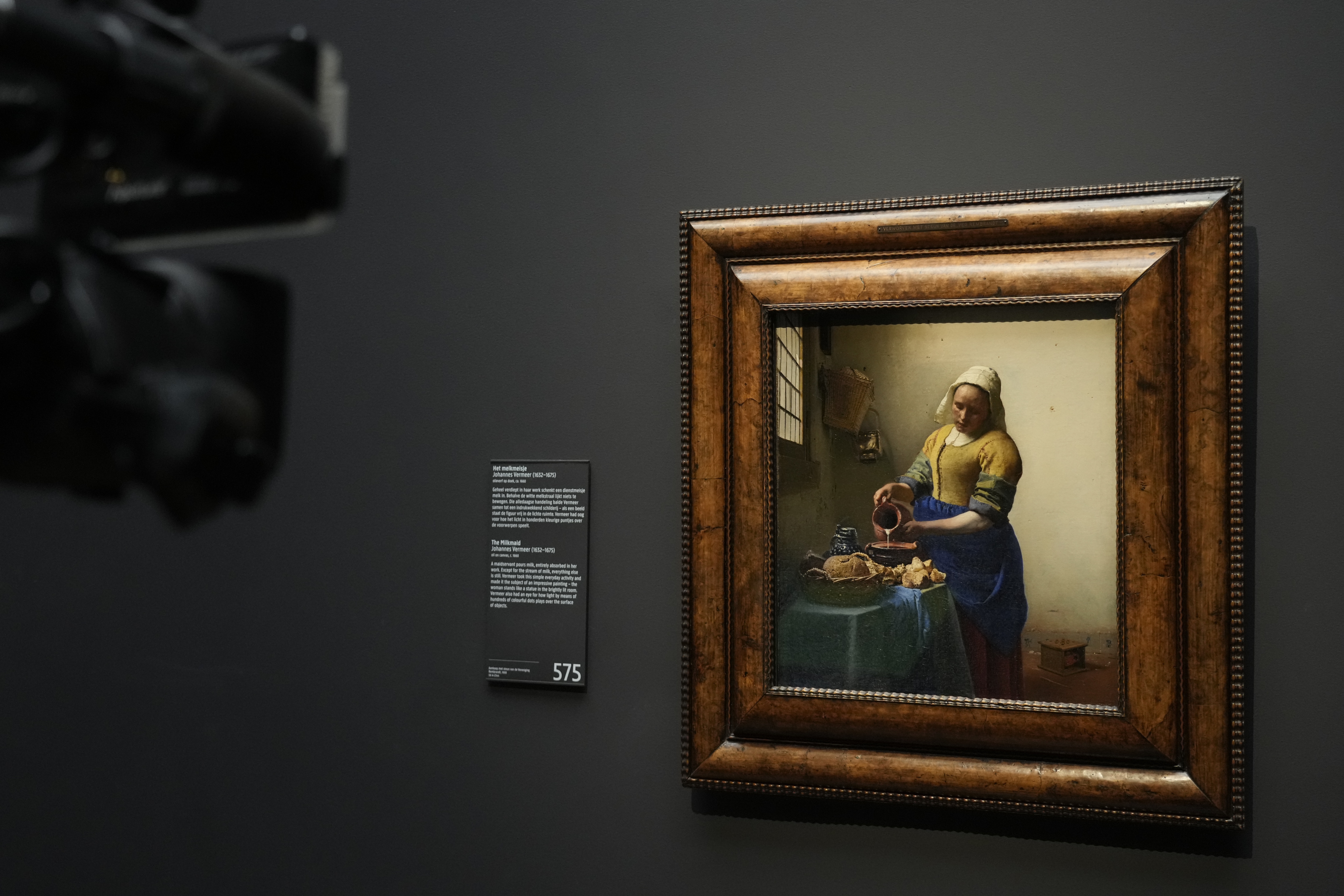 Vermeer's The Milkmaid is filmed during a press conference at the Rijksmuseum in Amsterdam, Netherlands, Thursday, Sept. 8, 2022. In an unprecedented blockbuster exhibit, from Feb. 10, to June 4, 2023, the Rijksmuseum will unite two iconic paintings from Dutch artist Johannes Vermeer, &nbsp;(AP Photo/Peter Dejong) (AP)