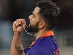 India's Virat Kohli holds the locket before kissing it as he celebrates scoring a century (AP) India's Virat Kohli holds the locket before kissing it as he celebrates scoring a century (AP)
