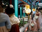 Women in traditional Chinese Hanfu clothing hold lanterns, pose for photos before Mid-Autumn festival at Wong Tai Sin temple in Hong Kong, China. &nbsp;