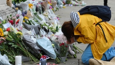 Queen Elizabeth II Passes Away: A woman reacts in front of Buckingham Palace, following the passing of Britain's Queen Elizabeth. (Reuters)