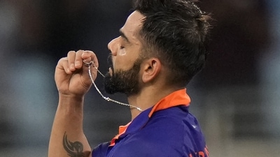 India's Virat Kohli holds the locket before kissing it as he celebrates scoring a century (AP) India's Virat Kohli holds the locket before kissing it as he celebrates scoring a century (AP)