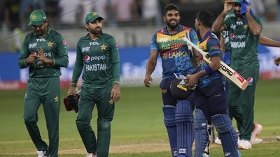 Sri Lankan batsmen Wanindu Hasaranga de Silva, third left, and Pathum Nissanka leave the field with Pakistan players at the end of the T20 cricket match of Asia Cup between Pakistan and Sri Lanka