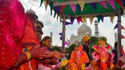 Devotees at a Ganapati Visarjan procession in the backdrop of Taj Mahal, in Agra, Wednesday. (PTI) Devotees at a Ganapati Visarjan procession in the backdrop of Taj Mahal, in Agra, Wednesday. (PTI)