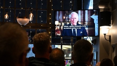 People in the Prince of Wales pub in central London watch a televised address by Britain's King Charles III, (AFP) People in the Prince of Wales pub in central London watch a televised address by Britain's King Charles III, (AFP)