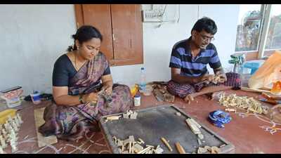 Artisans at work crafting wood-based toys in Vijaywada. (HT Photo)