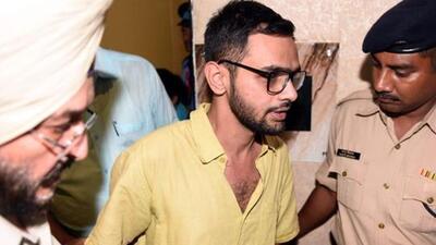 New Delhi, India- August 13, 2018: Delhi police officials with JNU student Umar Khalid who escaped unhurt after an unidentified man shot at him, outside the Constitution club at Rafi Marg in Central Delhi, India on Monday, August 13, 2018. (Photo by Sonu Mehta/ Hindustan Times) (Sonu Mehta/HT PHOTO) New Delhi, India- August 13, 2018: Delhi police officials with JNU student Umar Khalid who escaped unhurt after an unidentified man shot at him, outside the Constitution club at Rafi Marg in Central Delhi, India on Monday, August 13, 2018. (Photo by Sonu Mehta/ Hindustan Times) (Sonu Mehta/HT PHOTO)