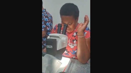 The image, taken from the Instagram video, shows the student's reaction after using a microscope for the first time.(Instagram/@goodnews_movement)