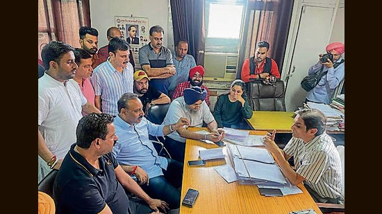 Former MLA Sanjay Talwar talking to Ludhiana municipal town planner Rajnish Wadhwa on Friday. (HT Photo)