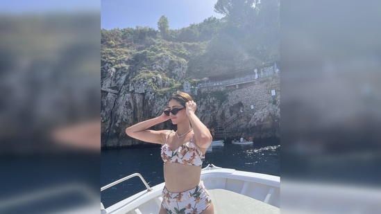 Ananya Panday put on her luxury black sunglasses and gave a candid pose for the camera in her floral bikini.(Instagram/@ananyapanday)