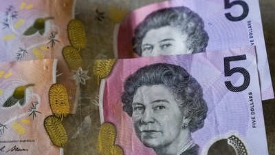 King Charles III's Ascension: Australian $5 notes are pictured in Sydney. (AP) King Charles III's Ascension: Australian $5 notes are pictured in Sydney. (AP)