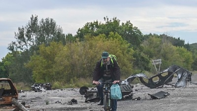 A bike rider cycles in the street in Balakliya, Kharkiv region, on September 10, 2022, amid the Russian invasion of Ukraine. (AFP) A bike rider cycles in the street in Balakliya, Kharkiv region, on September 10, 2022, amid the Russian invasion of Ukraine. (AFP)