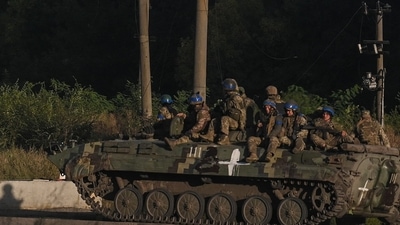 Russia-Ukraine War: Ukrainian army's fighters sit on the top of an armed vehicle in Kharkiv. (AFP) Russia-Ukraine War: Ukrainian army's fighters sit on the top of an armed vehicle in Kharkiv. (AFP)