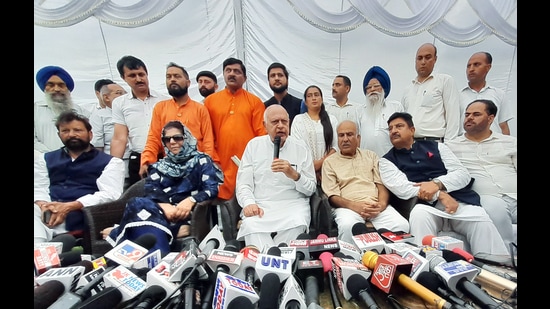 National Conference (JKNC) chief Farooq Abdullah addresses a press conference as PDP chief Mehbooba Mufti and others look on in Jammu on Saturday. (ANI)
