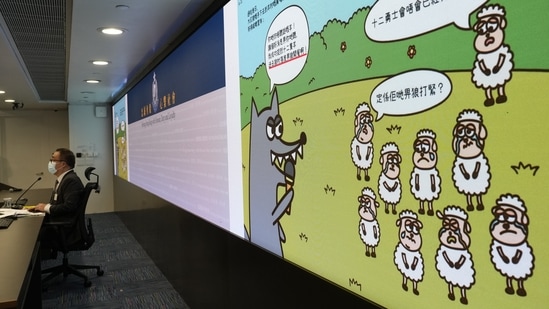 FILE - A screen showing evidence of three children's books that revolve around a village of sheep which has to deal with wolves from a different village, before a press conference in Hong Kong on July 22, 2021.&nbsp;(AP)