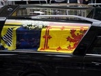 The hearse carrying the coffin of Queen Elizabeth II, draped with the Royal Standard of Scotland, on its way to the Palace of Holyroodhouse in Edinburgh, where it will lie in rest for a day, Sunday.(AP) The hearse carrying the coffin of Queen Elizabeth II, draped with the Royal Standard of Scotland, on its way to the Palace of Holyroodhouse in Edinburgh, where it will lie in rest for a day, Sunday.(AP)