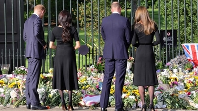 The Duke and Duchess of Sussex and the new Prince and Princess of Wales look at floral tributes laid by members of the public on the Long Walk at Windsor Castle.&nbsp; (AFP)