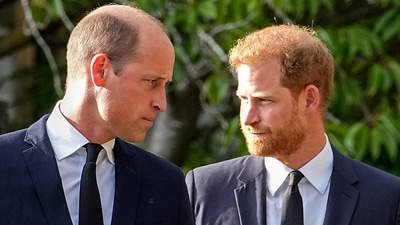 Britain's Prince William and Britain's Prince Harry walk beside each other after viewing the floral tributes for the late Queen Elizabeth II outside Windsor Castle, in Windsor.&nbsp; (AP)