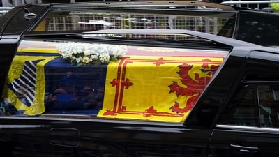 The hearse carrying the coffin of Queen Elizabeth II, draped with the Royal Standard of Scotland, on its way to the Palace of Holyroodhouse in Edinburgh, where it will lie in rest for a day, Sunday. (AP)
