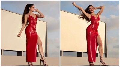 In a sensual red high-slit latex dress, Jacqueline Fernandez turns heads. She wore a body-hugging outfit with straps and a low neckline for a daring twist. Stilettos with cross straps completed her outfit. Jacqueline enhanced her appearance by contouring her cheekbones, using a light brown eyeshadow, and adding a touch of the same shade to her lips. (Instagram/Jacqueline Fernandez) In a sensual red high-slit latex dress, Jacqueline Fernandez turns heads. She wore a body-hugging outfit with straps and a low neckline for a daring twist. Stilettos with cross straps completed her outfit. Jacqueline enhanced her appearance by contouring her cheekbones, using a light brown eyeshadow, and adding a touch of the same shade to her lips. (Instagram/Jacqueline Fernandez)