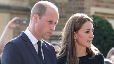 Britain's Prince William, Prince of Wales, (L) and his wife Britain's Catherine, Princess of Wales, look at floral tributes laid by members of the public on the Long walk at Windsor Castle on Saturday. (AFP) Britain's Prince William, Prince of Wales, (L) and his wife Britain's Catherine, Princess of Wales, look at floral tributes laid by members of the public on the Long walk at Windsor Castle on Saturday. (AFP)
