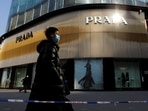 A man wearing a face mask walks past a store of Italian luxury brand Prada on a shopping street in Beijing, China, January 20, 2021.