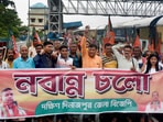 BJP supporters raise slogans before boarding a Kolkata-bound train to participate in the party's 'Nabanna Abhijan' march, to be held on Tuesday(PTI) BJP supporters raise slogans before boarding a Kolkata-bound train to participate in the party's 'Nabanna Abhijan' march, to be held on Tuesday(PTI)