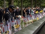 Colonel Davis looks at a photorgaph of her colleague, Captain Micheal Dermott Mullan, at the 9/11 Memorial in New York City. (AFP)