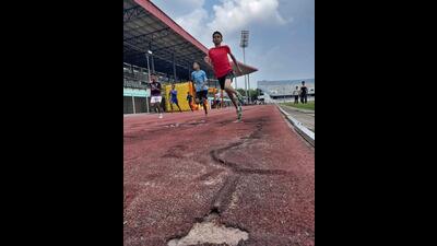 An athlete running on damaged synthetic track at the district-level sports event being held under Khedan Watan Punjab Diyan at Guru Nanak Stadium in Ludhiana. (Gurpreet Singh/HT)