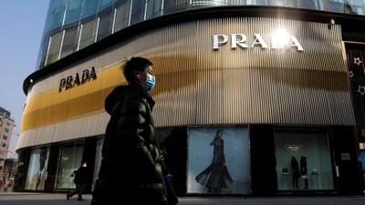 A man wearing a face mask walks past a store of Italian luxury brand Prada on a shopping street in Beijing, China, January 20, 2021. (REUTERS)