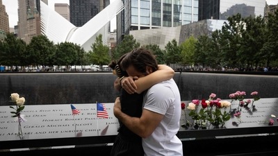 People embrace at the 9/11 Memorial in New York City. (AFP) People embrace at the 9/11 Memorial in New York City. (AFP)